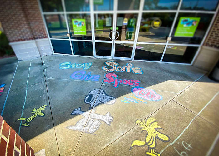 Sidewalk chalk art in front of bank doors