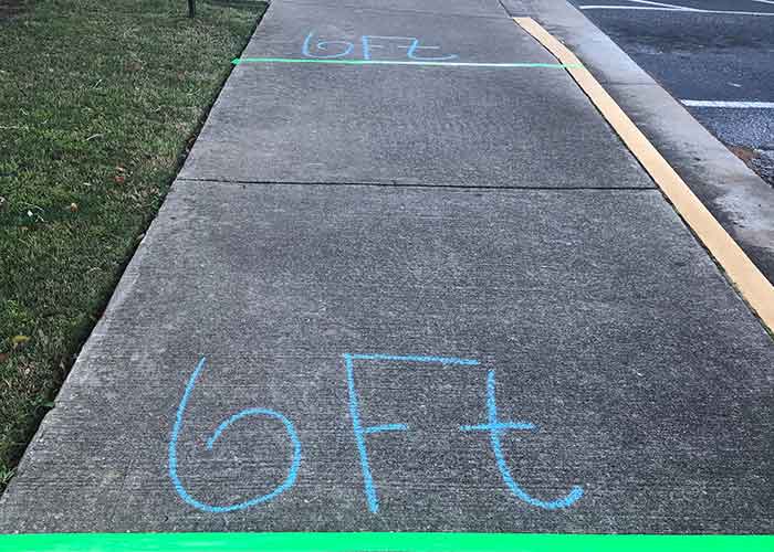 Sidewalk chalk marking 6 feet distances