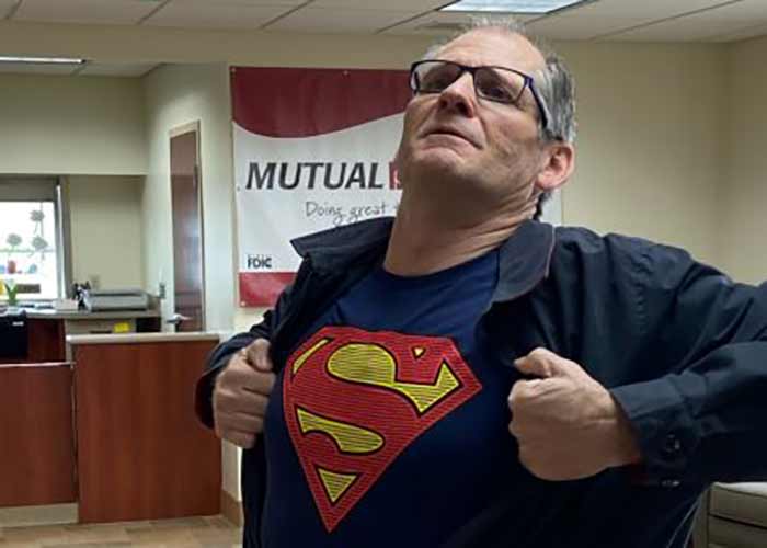 Banker wearing a "Superman" shirt