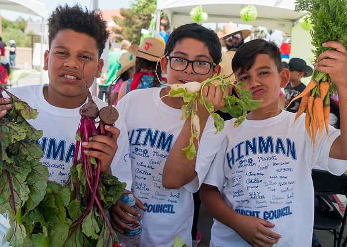 Kids showing food they've grown