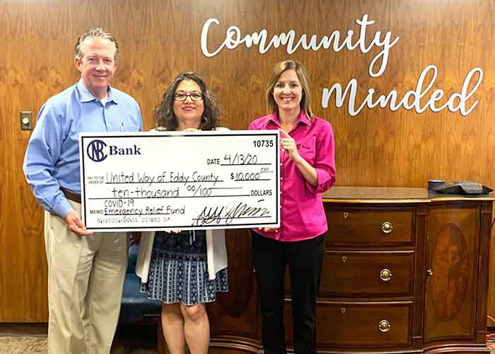 bankers holding a large check