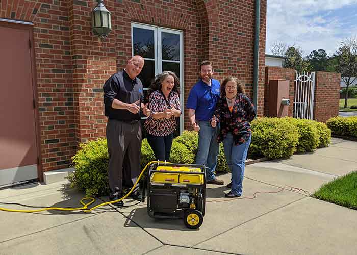 Bankers standing around a generator