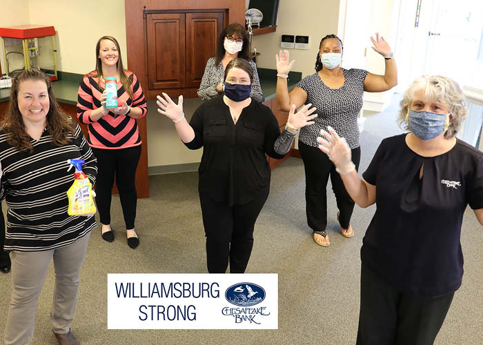 Chesapeake Bank employees wearing masks and holding cleaning supplies
